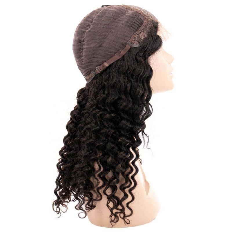 A side view of a mannequin head displays the hairdiamondz Deep Wave Transparent Closure Wig, crafted from virgin hair. The black curly wig features long, thick curls and is set on a transparent lace cap with adjustable straps. The mannequin's face is tilted slightly upward.