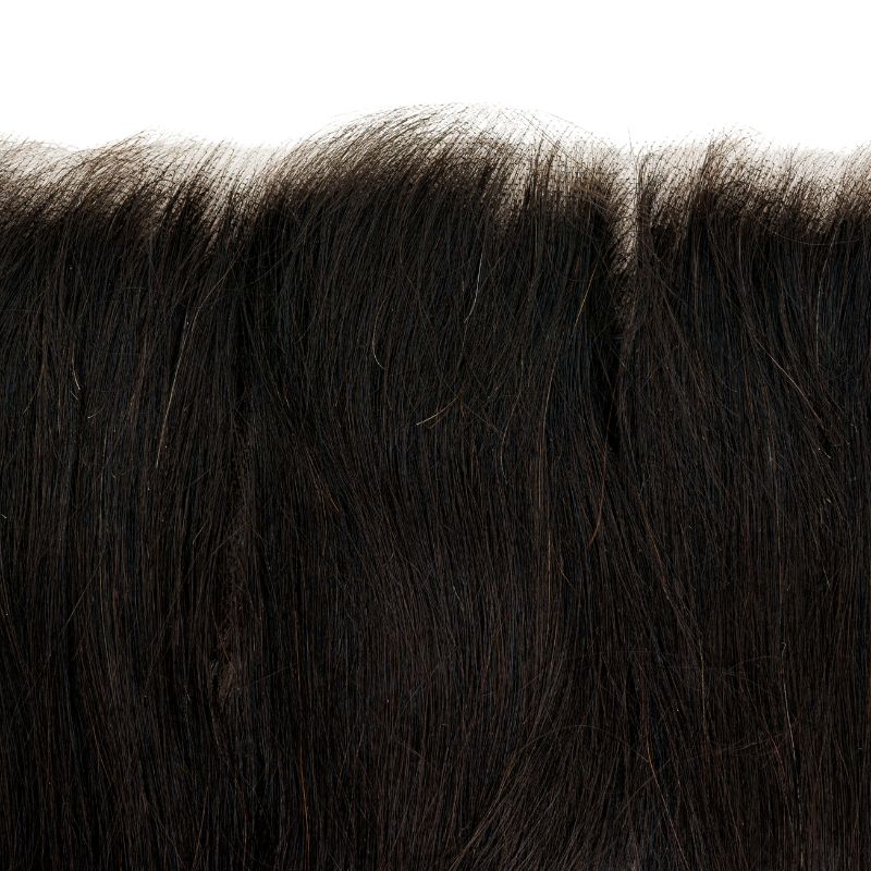 Close-up of hairdiamondz's Brazilian Straight HD 13"x6" Frontal, featuring a sleek and smooth texture that fills the frame. The glossy hair shines under the lights, with individual strands visible against a white background—ideal for anyone aiming for top-notch Brazilian HD Straight Frontal styles.