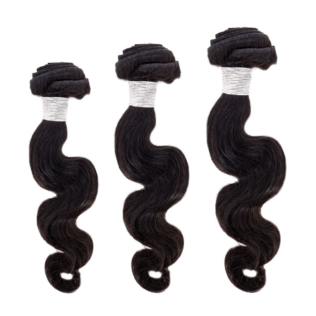 Three bundles of dark, wavy hair extensions are aligned vertically on a white background. The hair has a shiny texture and each bundle is tightly secured with visible silver ties at the top.