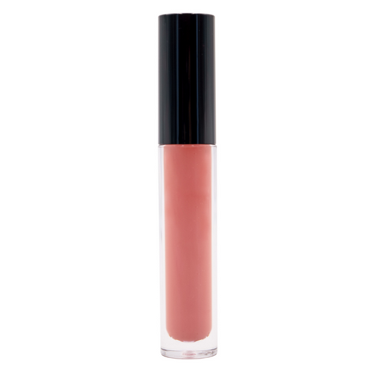 The New York Pink Matte Lipstick, featuring a glossy black cap and transparent body, displays a warm pink shade. This bold matte lip offers long-lasting color and moisturizing elements for added comfort, standing upright against a white background.